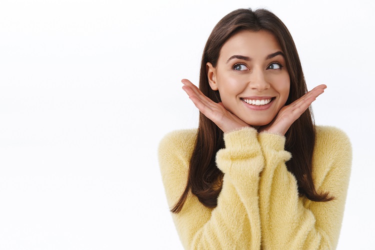 Cute beautiful and feminine young happy woman dreaming about vacation with boyfriend, paradise island honeymoon, look pleased and dreamy left side, leaning on hands, smiling white background